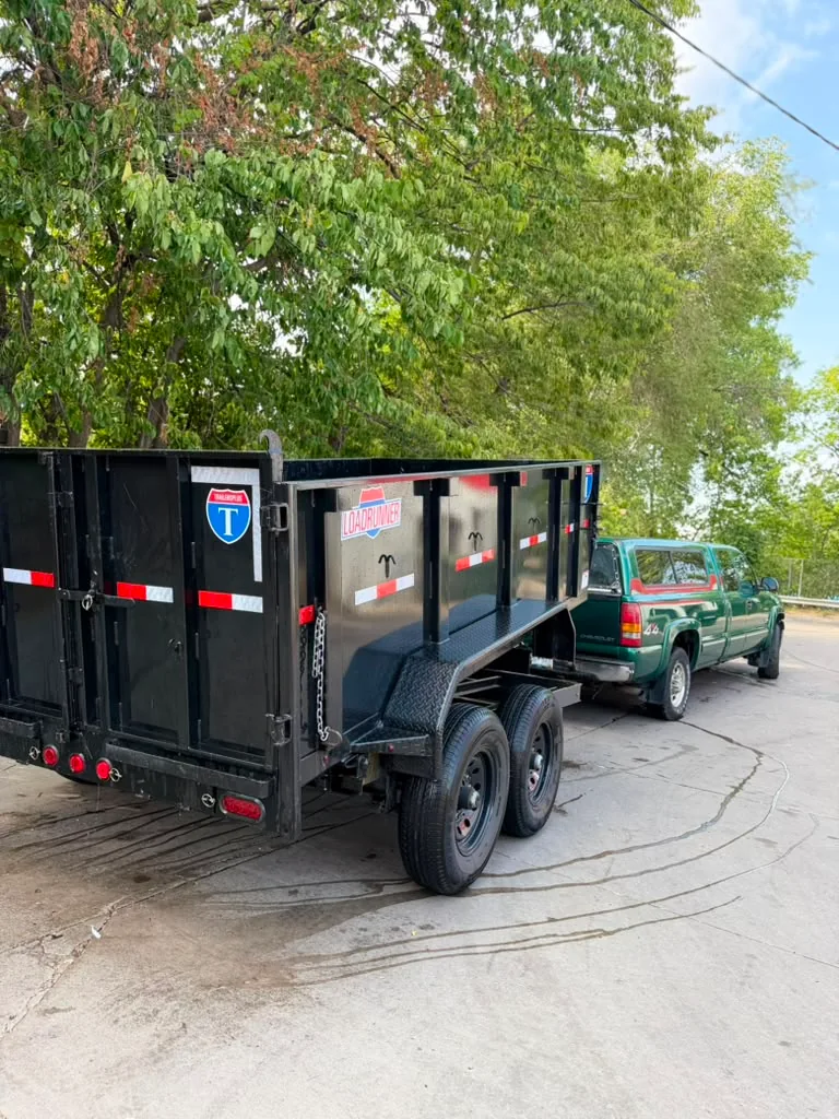 The new black MGM dump trailer attached to the green hauling pickup